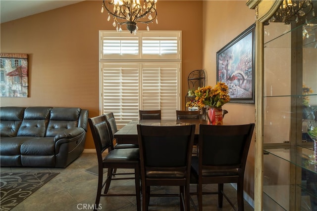 dining space with lofted ceiling and a notable chandelier