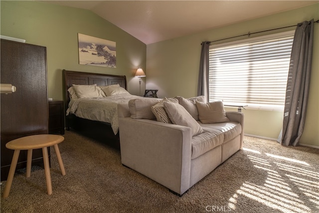 carpeted bedroom with lofted ceiling