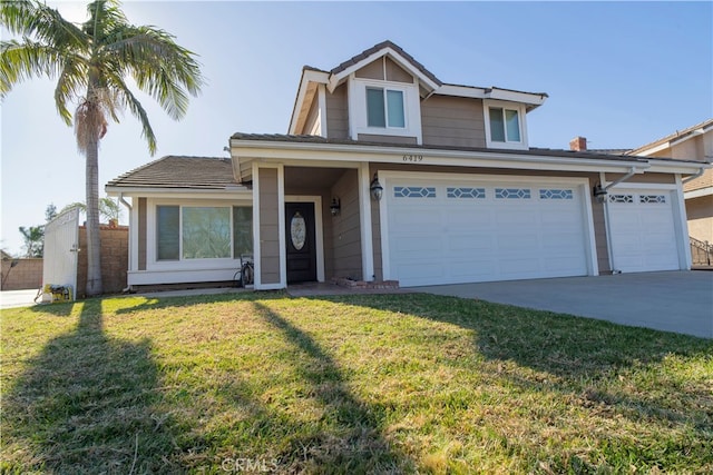 view of front of home with a front lawn and a garage