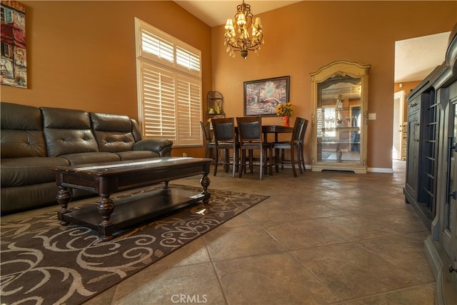 living room with high vaulted ceiling, dark tile patterned floors, a notable chandelier, and plenty of natural light