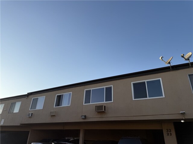 view of side of property with an AC wall unit