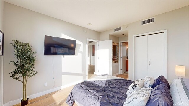 bedroom with a closet and light hardwood / wood-style flooring