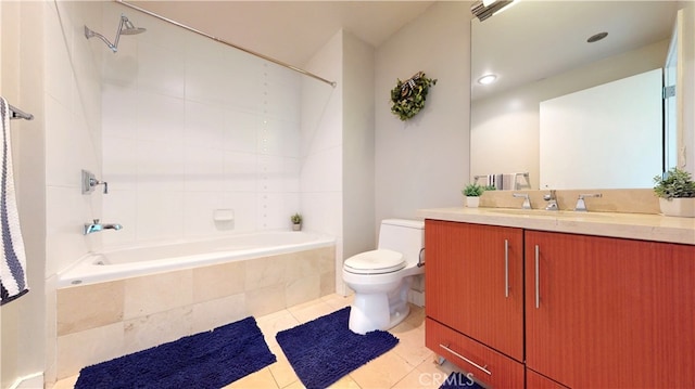 full bathroom featuring toilet, tile patterned flooring, tiled shower / bath, and vanity