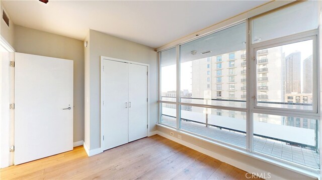 unfurnished bedroom featuring a closet and light hardwood / wood-style flooring