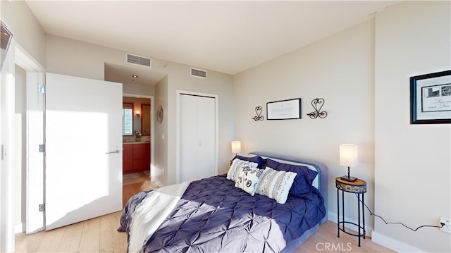 bedroom featuring light hardwood / wood-style flooring and a closet