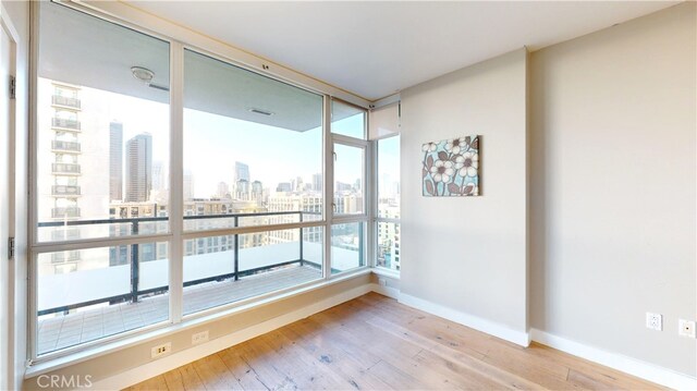 spare room with light hardwood / wood-style flooring