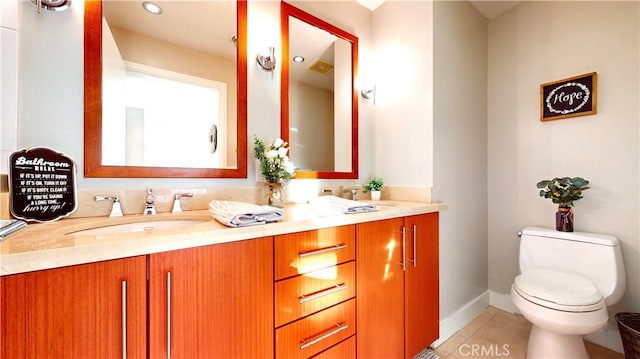 bathroom featuring toilet, vanity, and tile patterned flooring