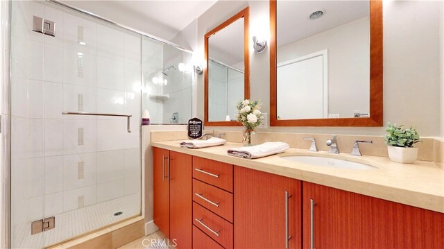 bathroom featuring tile patterned floors, an enclosed shower, and vanity