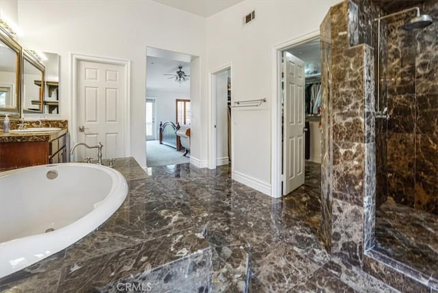 bathroom with ceiling fan, vanity, and separate shower and tub