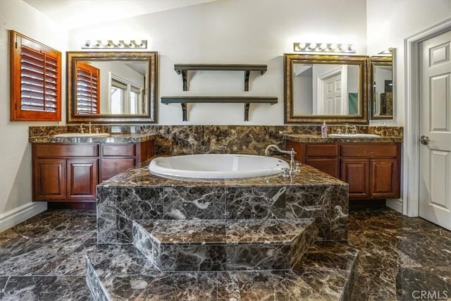 bathroom with lofted ceiling, tiled tub, and vanity