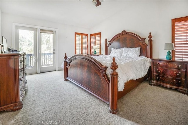 carpeted bedroom featuring access to exterior and lofted ceiling