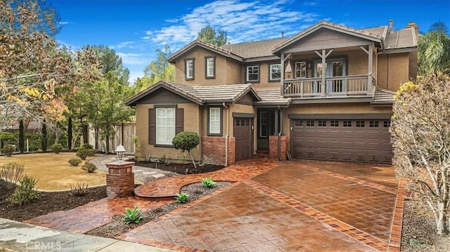 view of front of property with a balcony and a garage