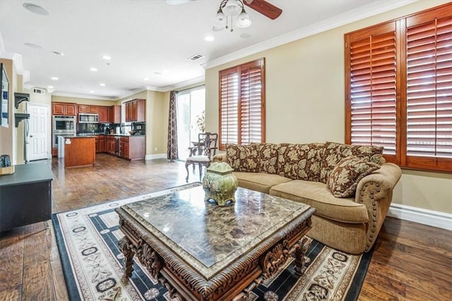 living room featuring ceiling fan, dark hardwood / wood-style flooring, and ornamental molding