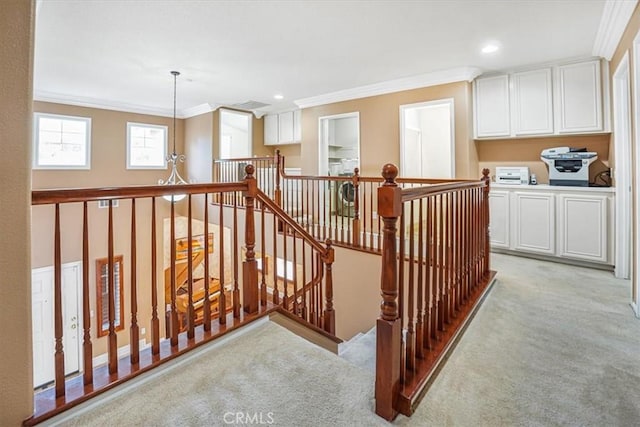 stairs with ornamental molding and carpet flooring