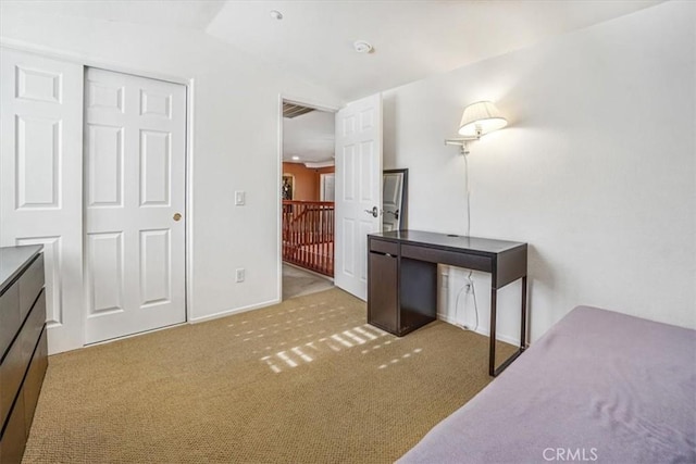 carpeted bedroom with a closet and vaulted ceiling