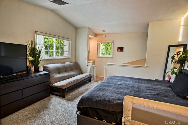 bedroom featuring lofted ceiling and light colored carpet