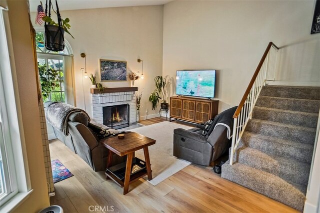 living room with a fireplace and light hardwood / wood-style flooring