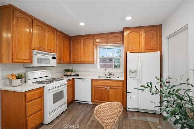 kitchen with dark hardwood / wood-style flooring, sink, and white appliances