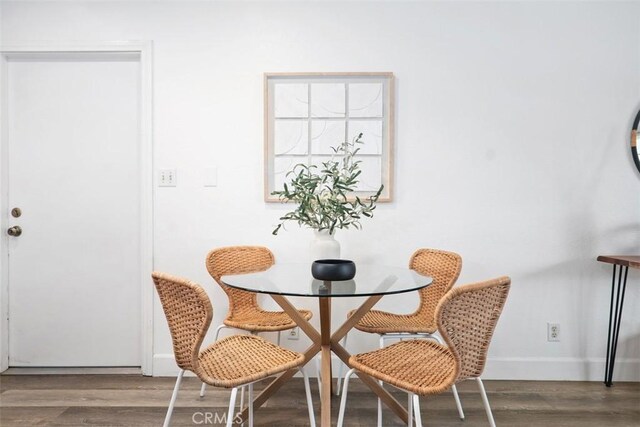 dining space with dark wood-type flooring