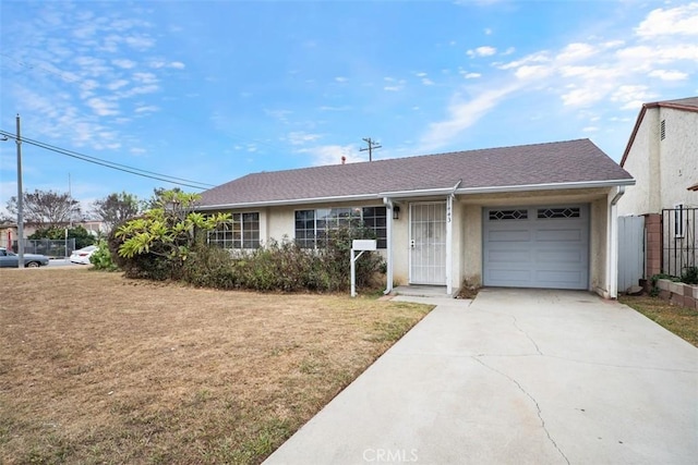 single story home featuring a front yard and a garage