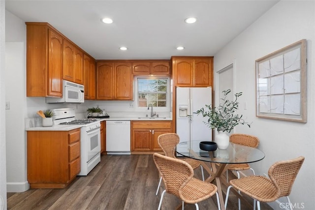 kitchen featuring dark hardwood / wood-style flooring, sink, and white appliances