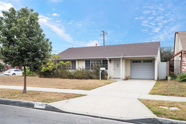 single story home with a garage and a front lawn