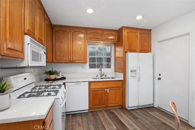 kitchen featuring sink, white appliances, and dark hardwood / wood-style flooring