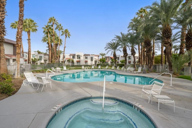 view of pool featuring a community hot tub and a patio