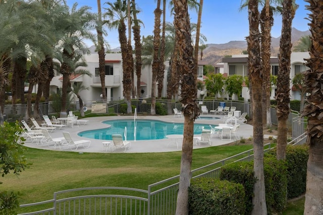 view of pool with a lawn, a mountain view, and a patio