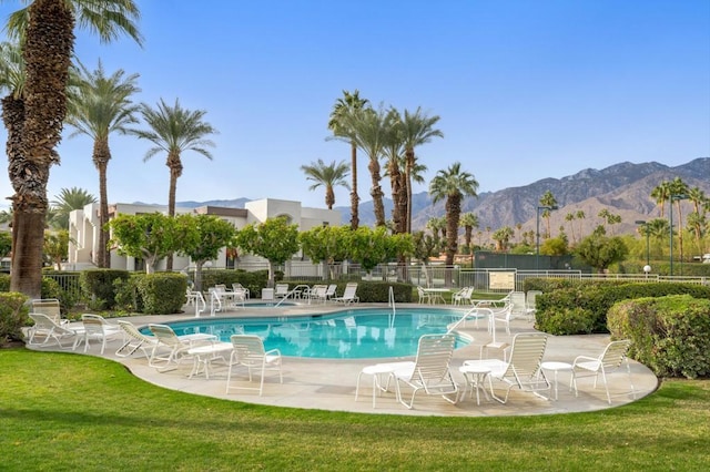 view of pool featuring a yard, a mountain view, and a patio