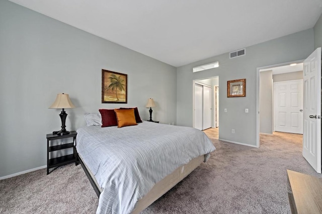 bedroom featuring light carpet and a closet