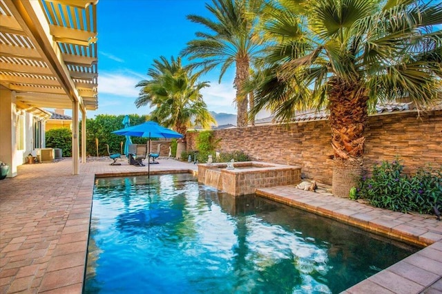 view of swimming pool with an in ground hot tub, a patio, and a pergola