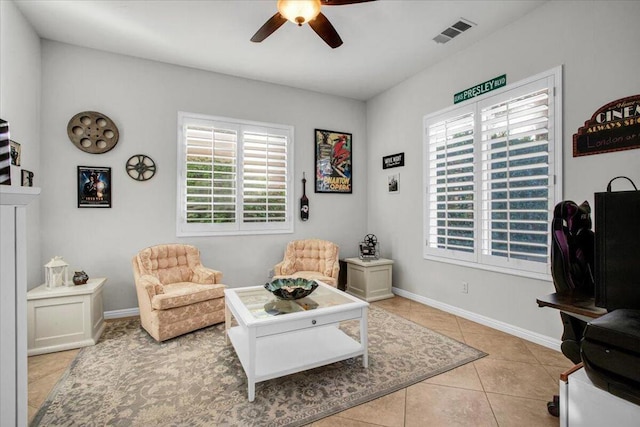 sitting room featuring ceiling fan and light tile patterned floors