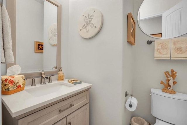 bathroom featuring toilet and vanity