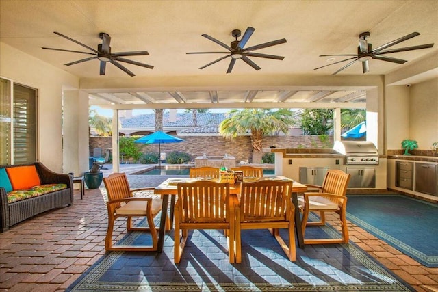 view of patio with ceiling fan, a grill, and area for grilling