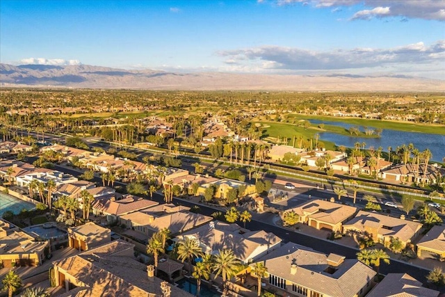 birds eye view of property with a water and mountain view