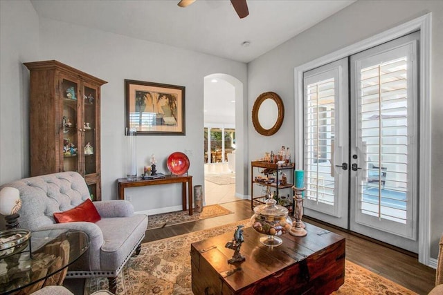 living room featuring ceiling fan, dark hardwood / wood-style floors, and french doors