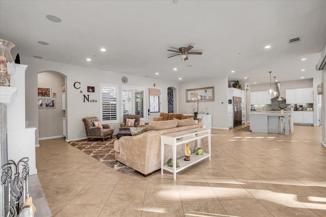 living room with ceiling fan and light tile patterned flooring