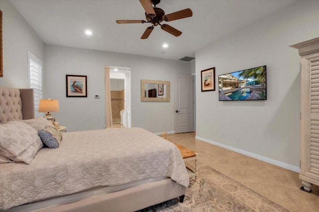 bedroom with ceiling fan, light tile patterned floors, and ensuite bathroom