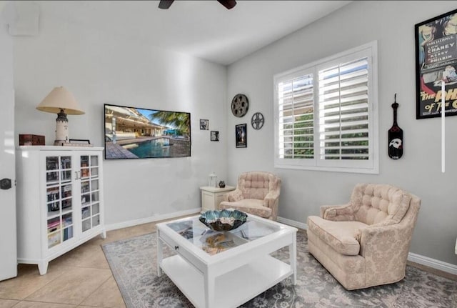 sitting room featuring ceiling fan and tile patterned floors