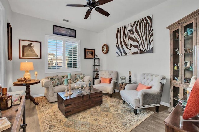 living room featuring hardwood / wood-style flooring and ceiling fan