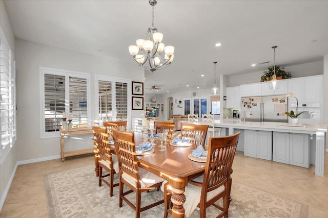 tiled dining room featuring ceiling fan with notable chandelier