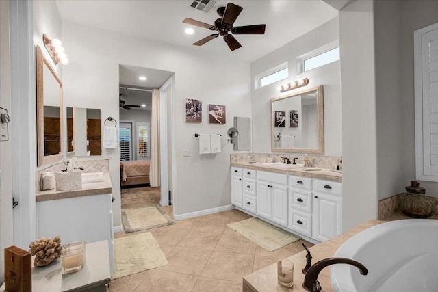 bathroom with tasteful backsplash, vanity, ceiling fan, tile patterned floors, and a washtub