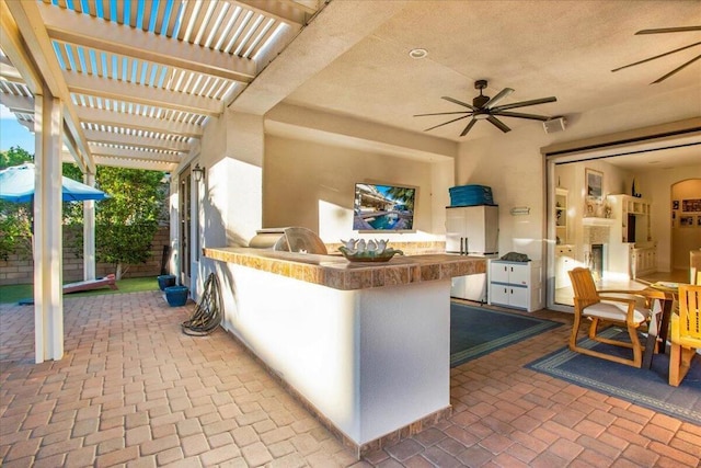 view of patio with a pergola, an outdoor kitchen, and an outdoor bar