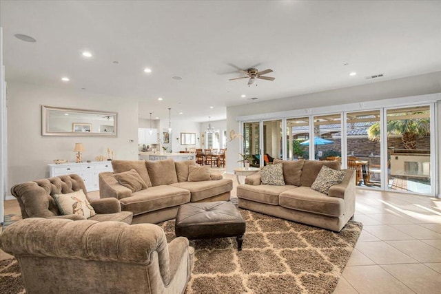 living room featuring ceiling fan and light tile patterned floors