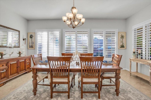 dining area featuring light tile patterned flooring and a chandelier