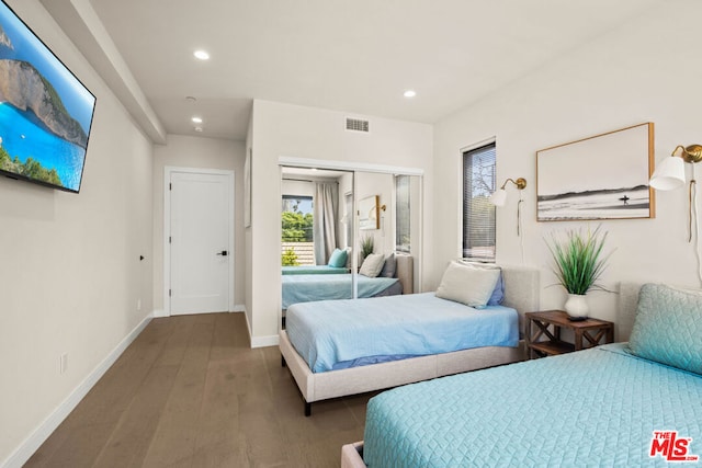 bedroom with hardwood / wood-style floors and a closet