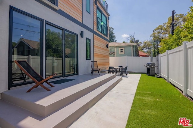 view of patio with a grill