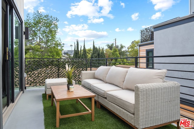 view of patio / terrace with an outdoor living space and a balcony