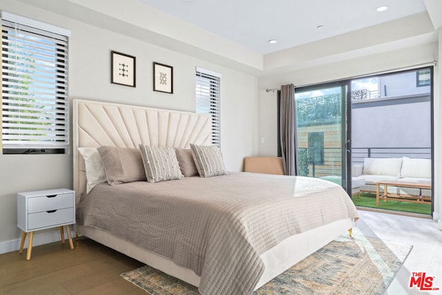 bedroom featuring dark hardwood / wood-style flooring and access to outside